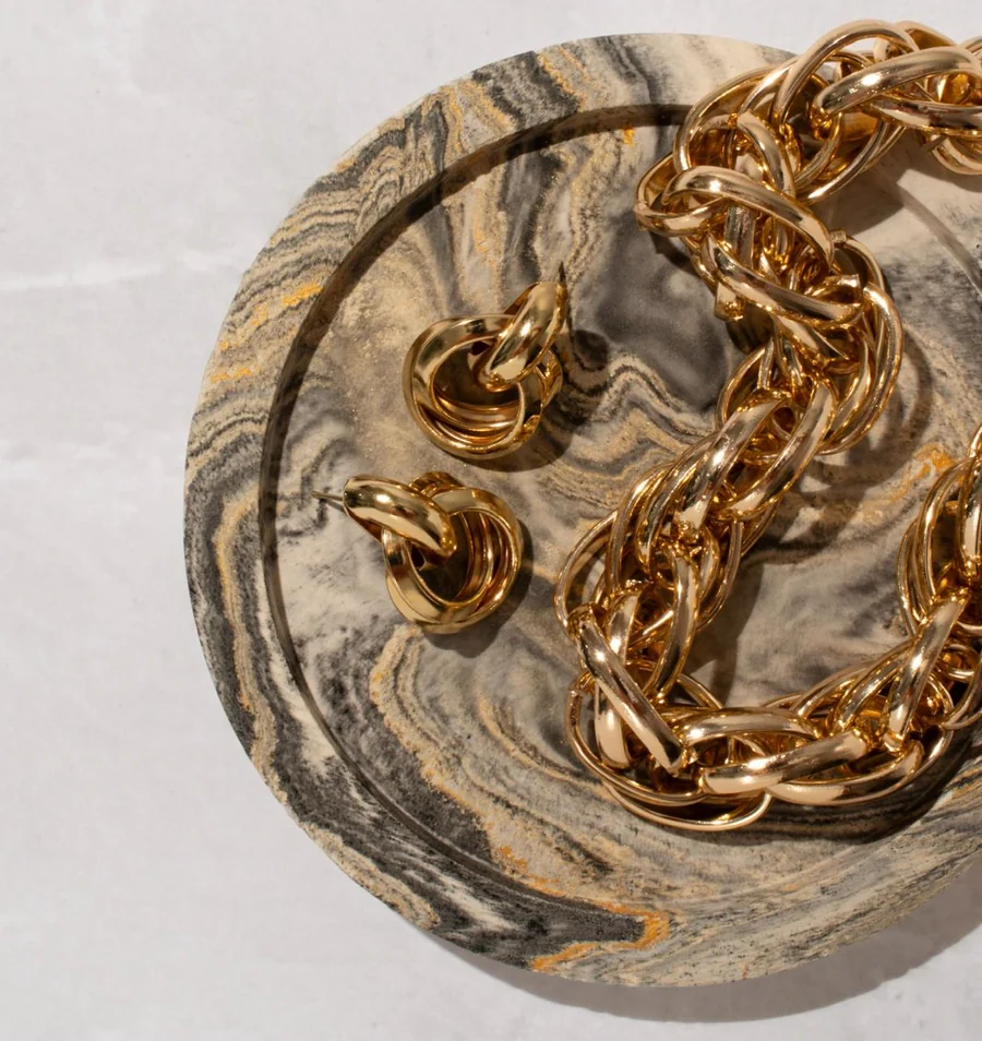 Cadena de oro sobre una plancha de mármol.